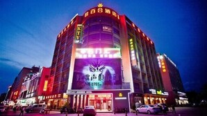 A multi-story hotel with a prominent digital display on the facade. - Jiabaihe Hotel (Buyong Subway Station Branch) (Shenzhen)