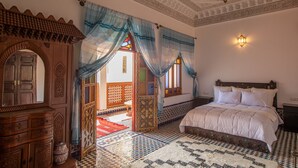 A traditional room with a bed, wooden furniture, patterned floor, and decorative ceiling. - Riad Sayeda Al Hora (Fes)