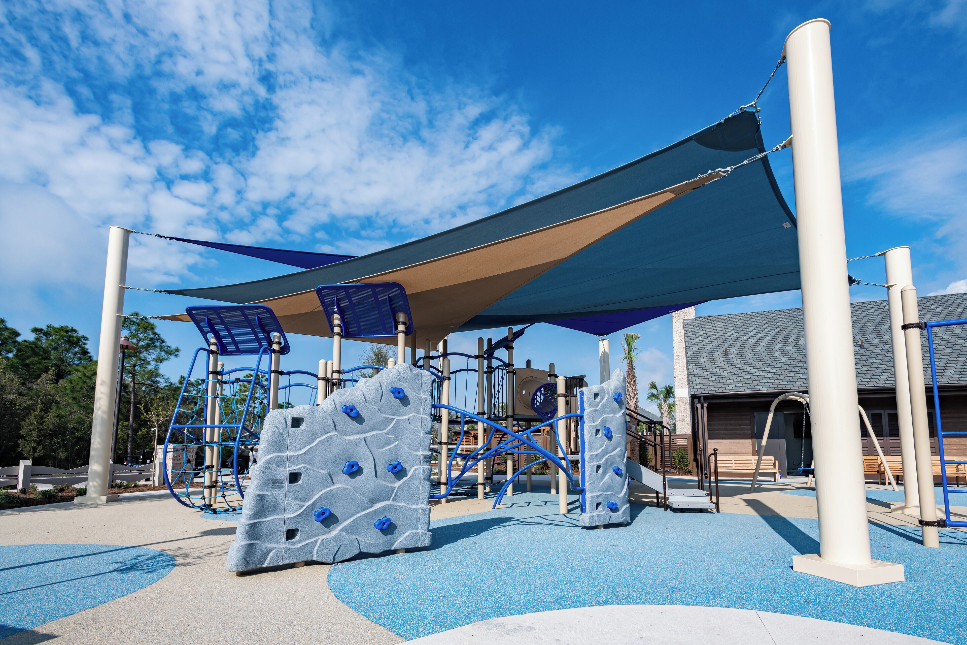 A playground with climbing structures and a shaded area.