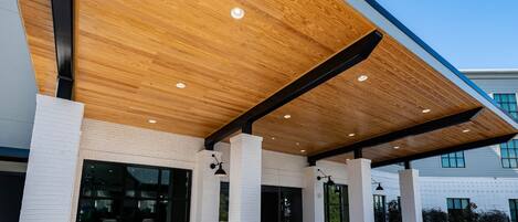 A modern building with a wooden ceiling and white brick walls.