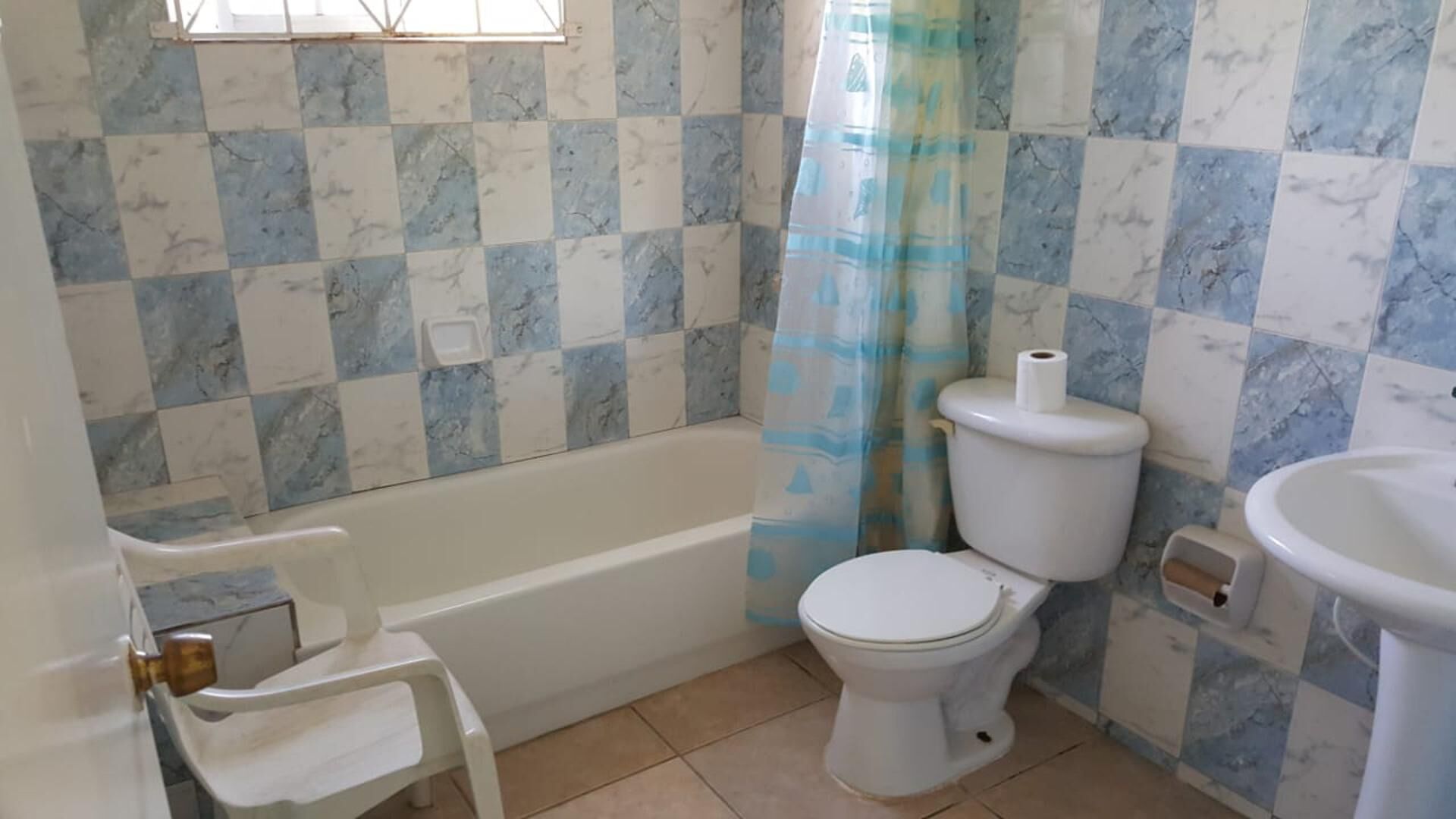 A bathroom with a bathtub, toilet, and sink.