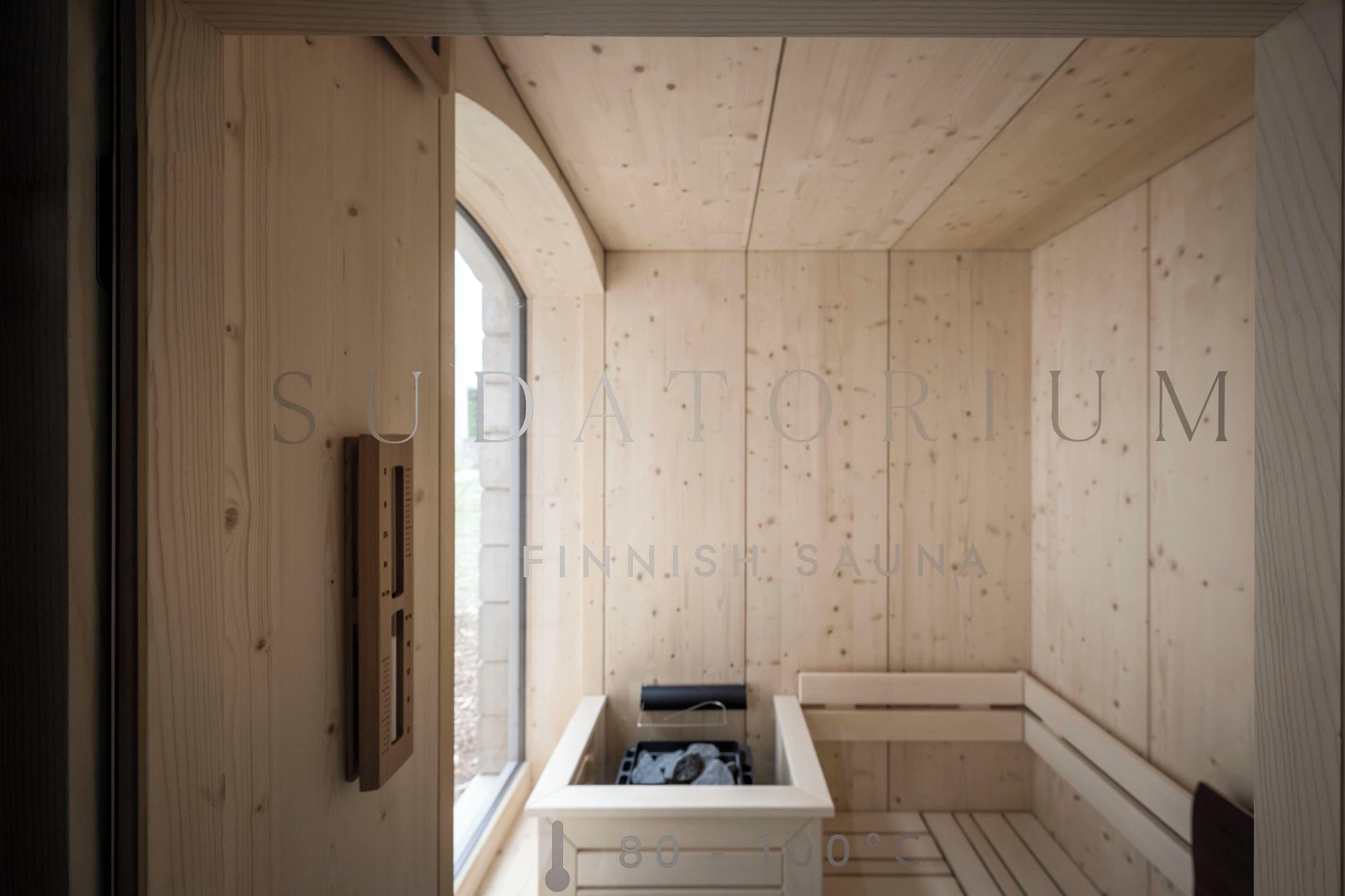 A sauna room with wooden walls and a bench.