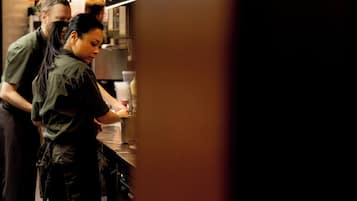 A kitchen area with a person preparing food.
