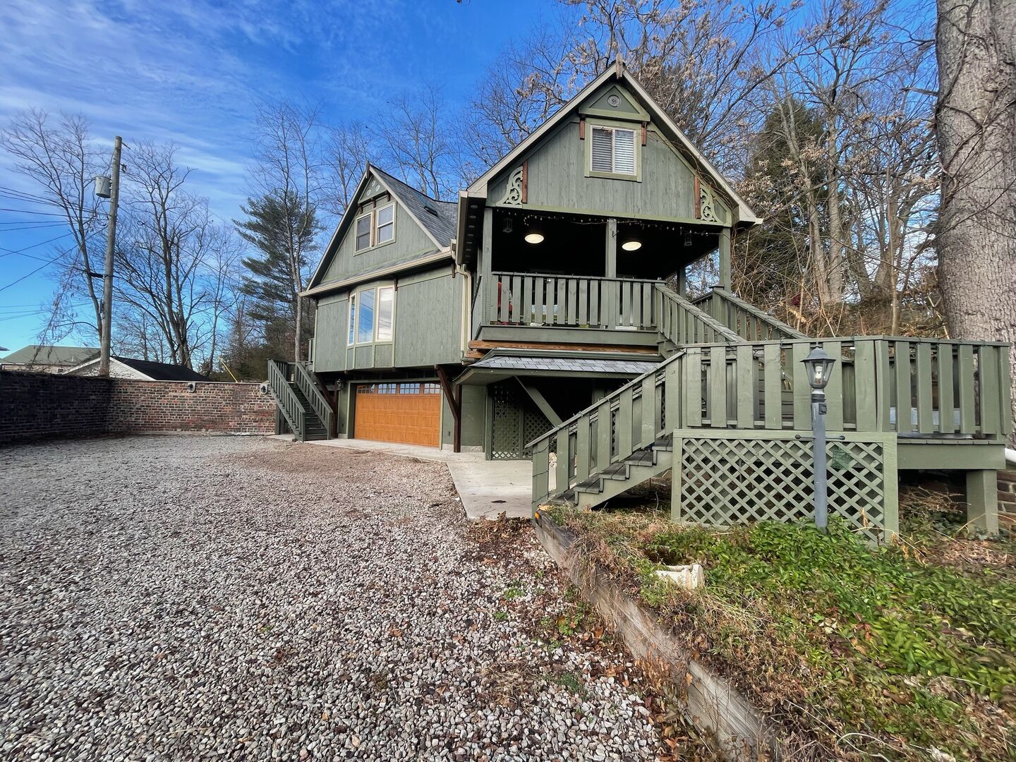 A two-story house with a front porch and a garage.