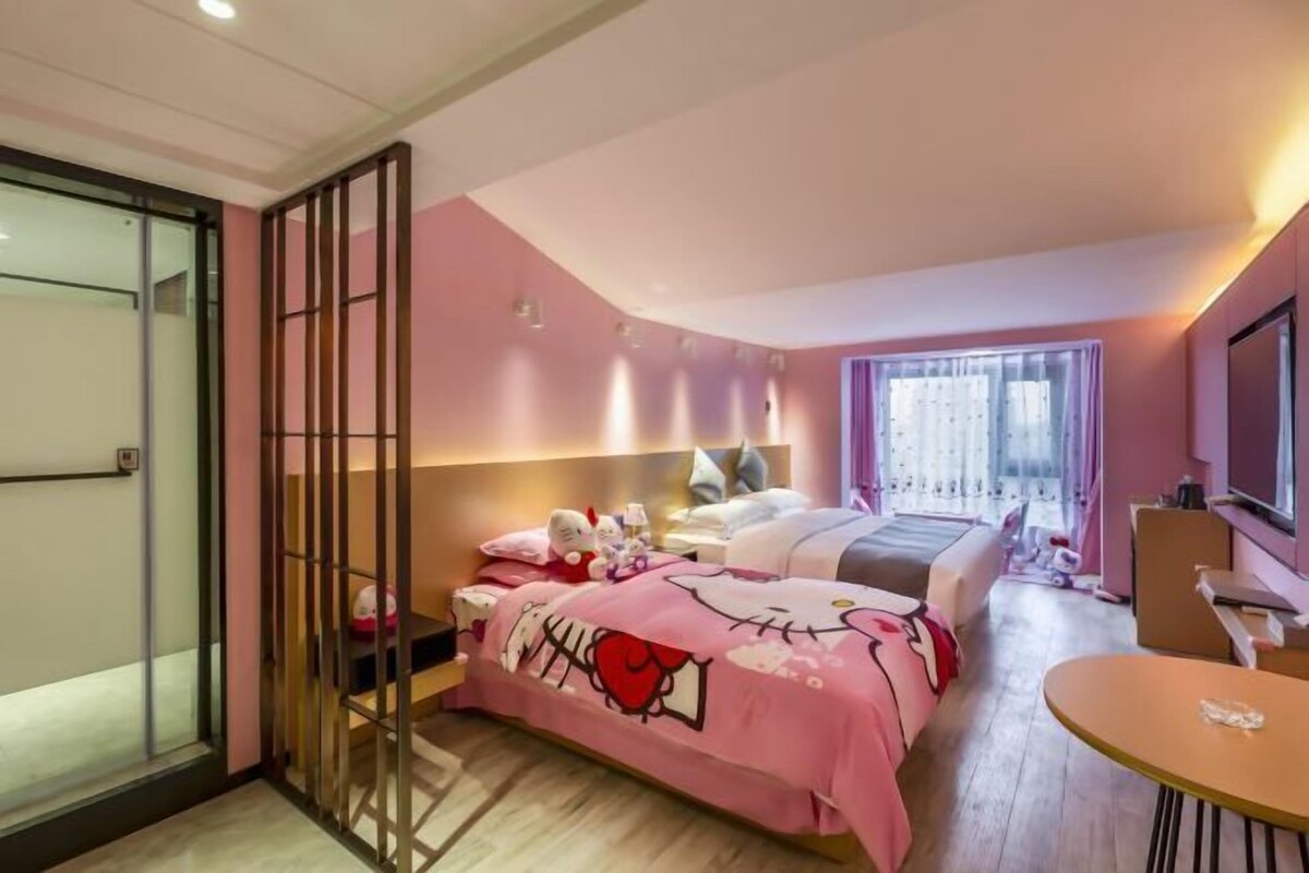 A bedroom with a bed, bedside tables, a desk, and a chair.