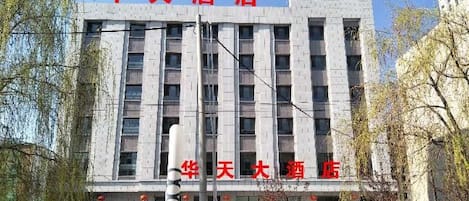 A hotel building with multiple floors and a prominent sign.