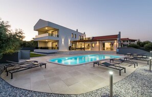 A modern two-story house with a swimming pool, outdoor seating, and a covered patio area. - Luxury Villa Immensity with Pool (Krnica)