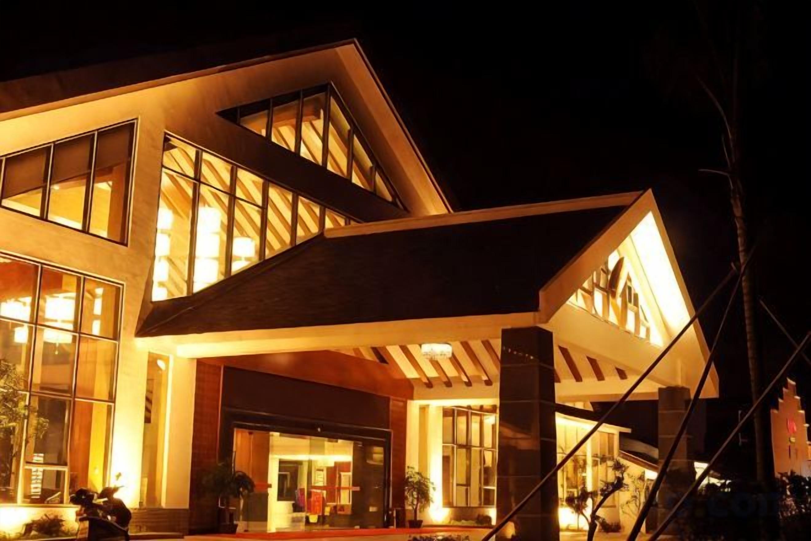 A modern building with a large entrance and multiple windows.