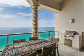 Enjoy ocean views from this balcony with a table, chairs, grill, and counter.