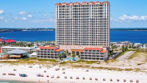 A high-rise hotel with multiple balconies, a beachside location, and a view of the ocean. - 3B Beach Club Penthouse BC 2104 - Daily Beach Chair Set! (Pensacola Beach)