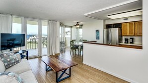 A modern apartment with a living room, dining area, and kitchen. - Beach and Bay Views at Santa Rosa Dunes! (Pensacola Beach)
