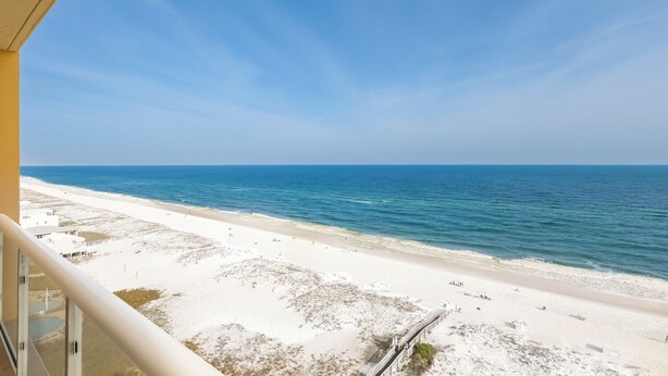 A beach view from a balcony with a clear sky. - 3B Gulf Front Paradise at Emerald Isle - 12th Floor (Pensacola Beach)