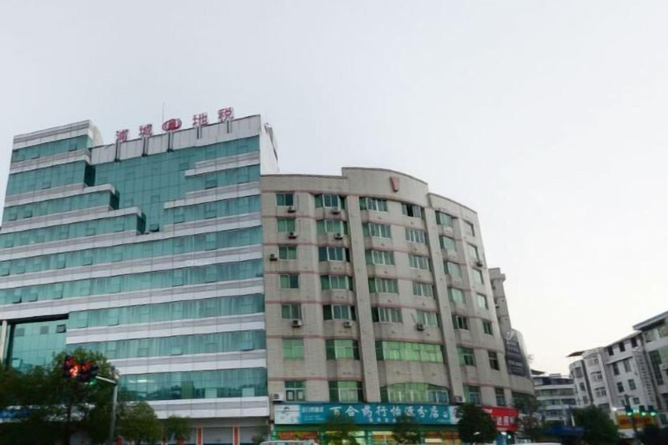 A multi-story building with a modern architectural design, featuring a prominent signage at the top.
