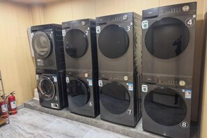 A row of stacked laundry machines in a facility. - Yiting Hotel (Hefei Economic Development Zone) (Hefei)