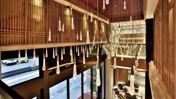 A modern interior with hanging light fixtures and wooden paneling. - Puchuan Hotel (Tongxiang)