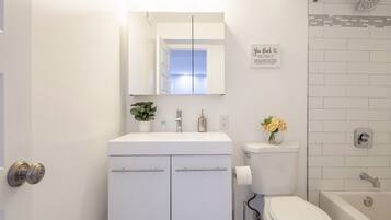 Combined shower/tub, hair dryer, towels, soap