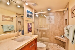 A bathroom with a large sink, a toilet, and a glass-enclosed shower. - Kihei, Maui - Fully Renovated, A/C, Pool, Tennis, Beach  (Kihei)