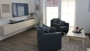 Een moderne woonkamer met een bank, een salontafel en een televisie.