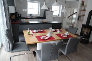A modern kitchen with a dining area.