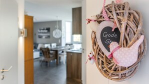 A wicker basket with a heart-shaped sign reading "Good Stuff" hanging on a wall. - Gode Stuuv - Our "good room" (75sqm) for 4 persons centrally located in Greetsiel (Krummhörn)