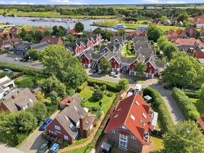 A residential area with houses, a marina, and a river.