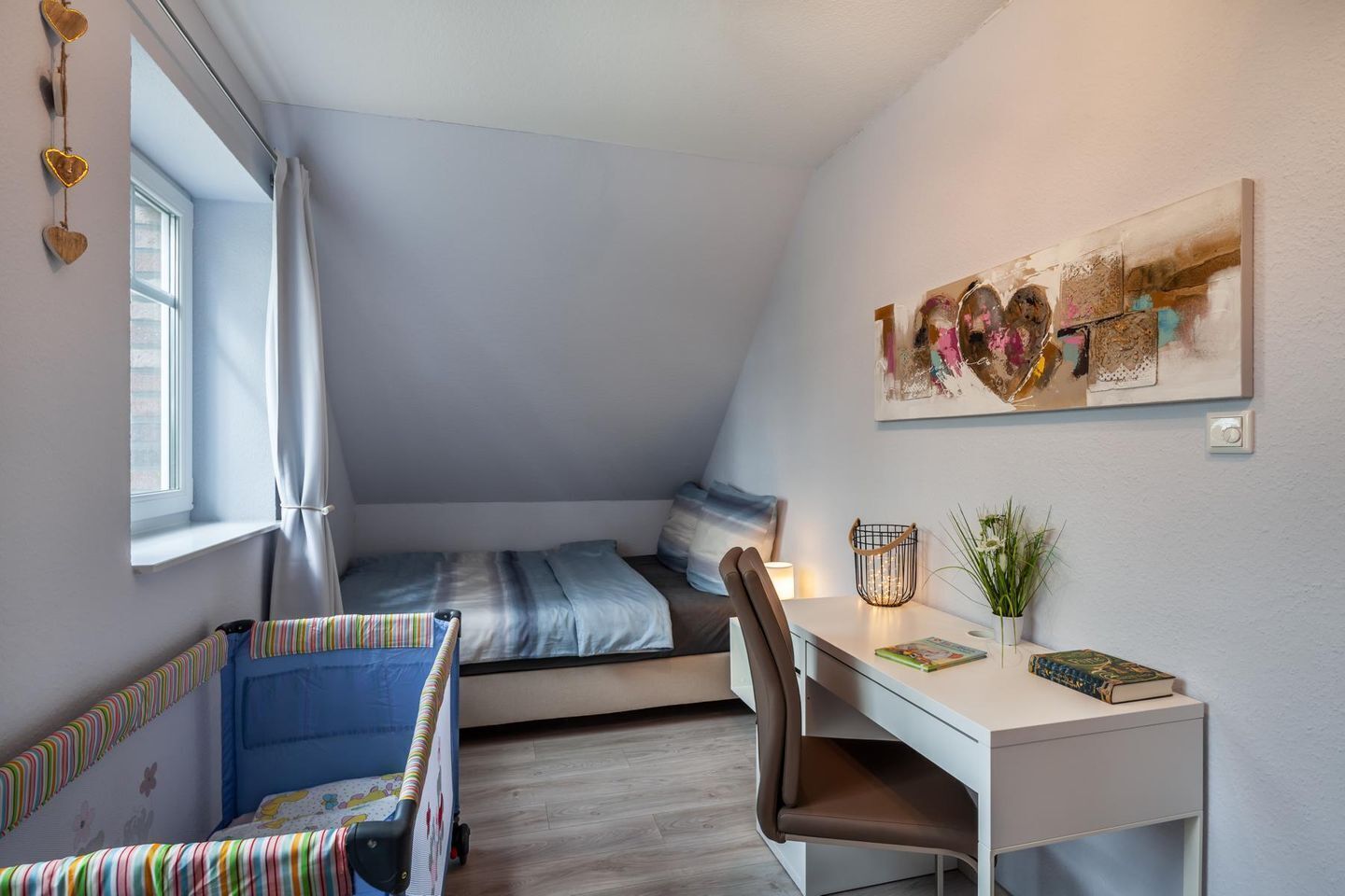 A compact bedroom with a bed, a desk, and a chair.
