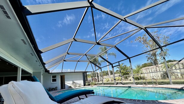 A poolside area with sun loungers and a clear view of the pool.