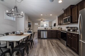 Enjoy cooking in this well-equipped kitchen with a central island, dishwasher, and stainless steel refrigerator.