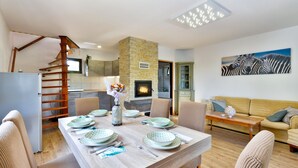 A modern living room with a dining area, a fireplace, and a staircase. - Jungle House With Pool and Hot Tub, Sveti Ivan Zelina, Croatia (Sveti Ivan Zelina)