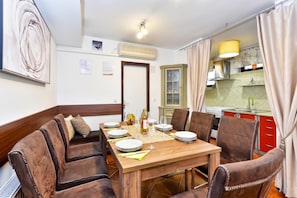 A dining area with a wooden table set for four, surrounded by leather chairs. - Twin Oasis Retreat with Pool & Spa, Sveti Ivan Zelina, Croatia (Sveti Ivan Zelina)
