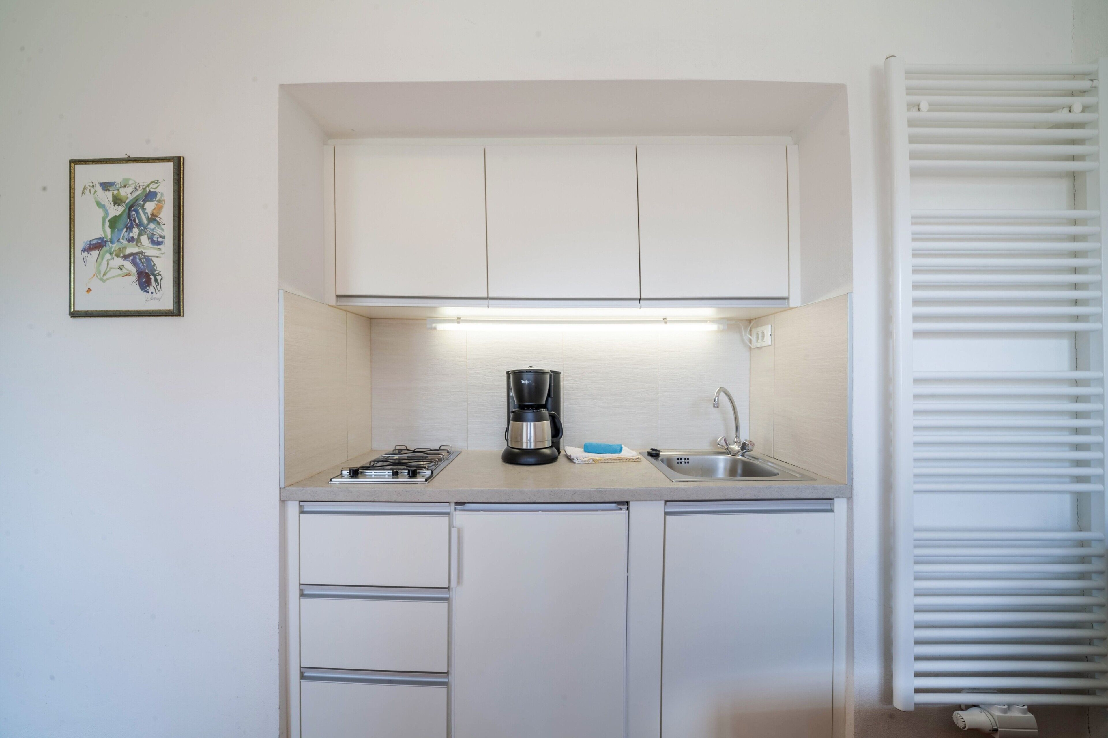 Fridge, stovetop, coffee/tea maker, cookware/dishes/utensils