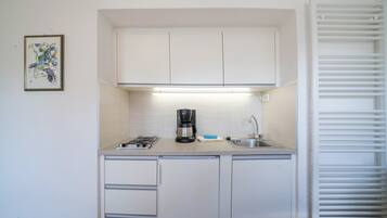 Fridge, stovetop, coffee/tea maker, cookware/dishes/utensils