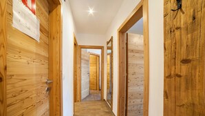A wooden hallway with doors leading to other rooms.