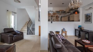 A spacious living area with a staircase, a dining area, and a kitchen. - Holiday Home Casa Curumbico with Sea & Mountain View, Garden and Wi-Fi (Almunecar)