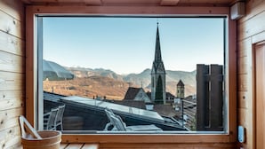 A wooden cabin with a large window overlooking a village and mountains. - Apartment 'Villa KaTo' with Lake View, Garden & Terrace (Kaltern an der Weinstraße)