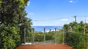 A wooden deck with a metal railing overlooking a coastal area. - Marengo Panoramic Ocean Views (Marengo)