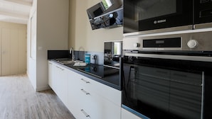 A modern kitchen with a Bosch microwave, oven, and a built-in TV. - Sunny appartment for 6 people (Le Bois-Plage-en-Ré)