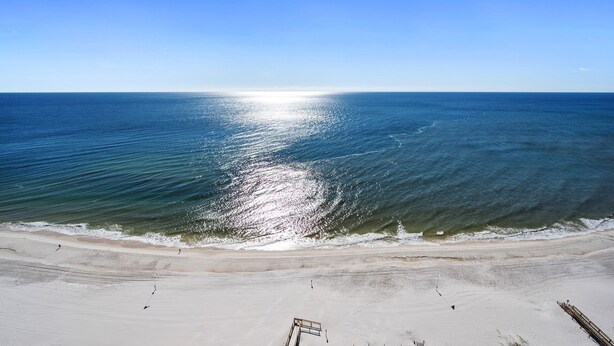 A beach with a clear view of the ocean and a sandy shore. - Phoenix West 2101 | 4BR/4BA Gulf-Front Condo | Oversized Balcony + Lazy River (Orange Beach)