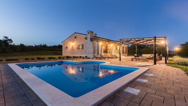 A house with a swimming pool, a covered patio, and a well-lit outdoor area. - Modern Villa Elida with pool (Heki)
