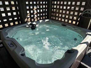 A hot tub with a wooden deck surrounding it. - Mermaid Way - beach 5 min walk, pool w/heater, hot tub, game room, pet friendly  (Kill Devil Hills)