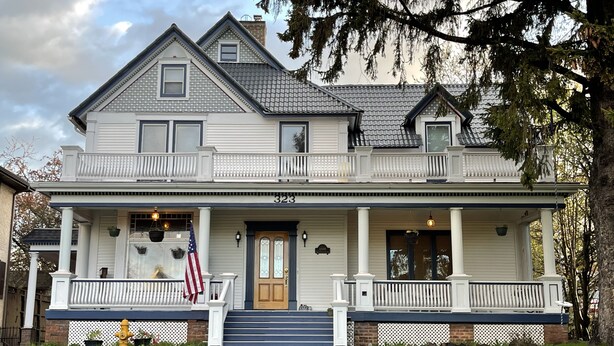 A two-story house with a front porch, a front door, and a number "323" on the front. - Gateway to the North Shore! Spacious home 2.5 blocks from Lake Superior! (Two Harbors)