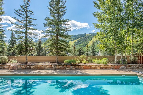 Surrounded by trees and rolling hills, this pool offers a serene escape.