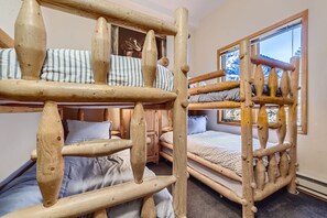 Cozy retreat with a rustic bunk bed and serene views of the surrounding landscape.