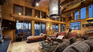 A spacious living area with a large sofa set, a coffee table, and a fireplace. - CP2450 | Breathtaking Views | Ski In/Out | Winter Shuttle (Steamboat Springs)