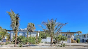 A residential area with multiple houses, palm trees, and a clear blue sky. - SKV 313 - Heated ❤ Pool, Walk to Village, Beach, Restaurants, Bars, Shopping!!! (Sarasota)