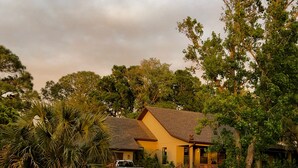 A two-story house with a driveway leading to the front door. - Tranquil Guest Suite in Paradise with Private Pool Walking Distance to Town
 (Saint Augustine)