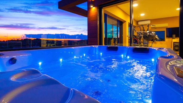 A hot tub with a cityscape view at dusk. - Villa Tiara with Pool (Premantura)
