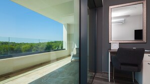 A modern hotel room with a balcony, a large mirror, and a desk with a chair. - Villa Tiara with Pool (Premantura)