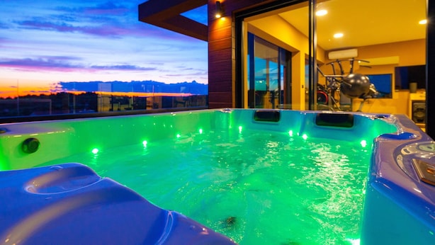 A hot tub with a sunset view, a bicycle, and a modern interior. - Villa Siena with Pool (Premantura)