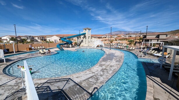A swimming pool with a water slide, lounge chairs, and a view of the surrounding area. - Escondido Luxury Resort, pool, slide, pickleball, 4 bedrooms, bunks, 2car garage (Washington)